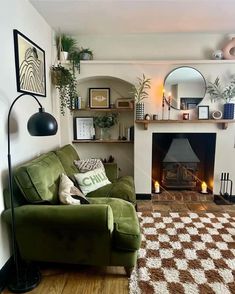 a living room filled with furniture and a fire place under a mirror on the wall