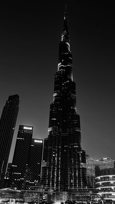 the burj building is lit up at night