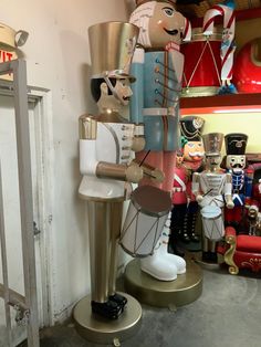 a collection of nutcrackers are on display in a room with red chairs