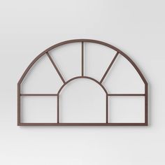 an arched window on the wall with no glass in it, against a white background