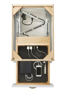 an electronic device in a wooden box with wires and plugs attached to the wall