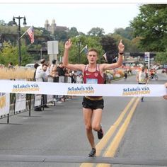 a woman crosses the finish line in a marathon