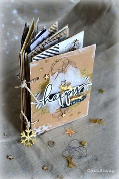 a close up of an open book on a table with confetti and paper