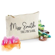 a white bag with some colorful hair clips in front of it and the words miss smith tools for school