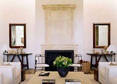 a living room filled with furniture and a fire place in the middle of a room