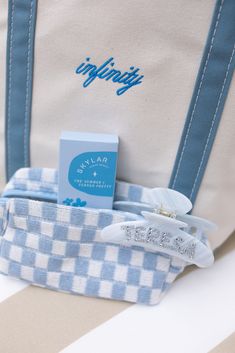 a blue and white tote bag with some items in it