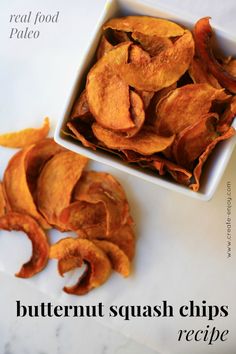 a white bowl filled with cut up sweet potato chips next to a pile of fried potato chips