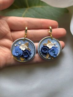 Stunning handcrafted polymer clay earrings with delicate blue flowers and a hypoallergenic, nickel-free half hoop stud. These earrings are designed to bring a touch of nature's beauty to your style with comfort in mind! Polymer clay is a lightweight material so it won't be heavy on the ears! These really are great for those with sensitive ears! Please note that each pair is made to order, ensuring a unique touch to every piece. As a result, the earrings you receive may vary slightly from the pic Fairycore Jewelry, Earrings Polymer Clay, Elegant Floral, Sensitive Ears, Blue Earrings, Polymer Clay Earrings, Clay Earrings, Blue Flowers, Favorite Jewelry