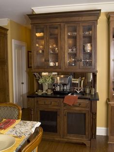 a kitchen with wooden cabinets and black counter tops, along with a dining room table