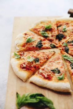 a pizza sitting on top of a wooden cutting board