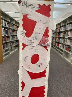 a sign in the middle of a library with writing on it that says i love you