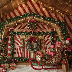 a christmas display with lights and decorations on the walls, including a sleigh