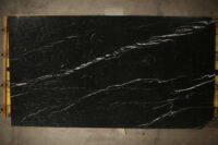 a black marble slab with gold trim