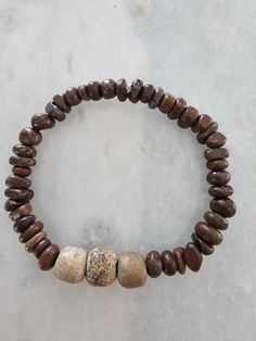 This womens bracelet is made of two types of dinosaur bone! In the center is stegodon bone . This was the gigantic predessesor to the mammoth and the elephant. The brown beads are another fossilised dinosaur bone. This stretch bracelet will fit up to an 8 inch wrist! If you love it grab it! Not ever sure of availability of these beads! Suttons Bay, Bone Bracelet, Bones Bracelet, Womens Bracelet, Dinosaur Bones, Handmade Wire Jewelry, Handmade Wire, Stretch Bracelet, Stretch Bracelets