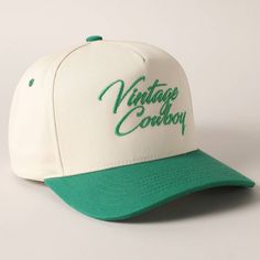 Vintage Cowboy Embroidery Two-Tone Baseball Cap - "Vintage Cowboy" Text Embroidery - 5 Panel Canvas Baseball Cap - 100% Cotton - Adjustable Buckle Closure - Embroidered In USA *One Size Fits All - Adjustable Strap Makes Fit Comfortable.* The VANTAGE Two-Tone Embroidery Trucker Hat blends style and functionality with its distinctive design. The hat features a two-tone color scheme, combining a vibrant or contrasting color on the front panels with a complementary. The embroidered detailing on the Vintage Cotton Snapback Hat With Embroidered Logo, Vintage Trucker Hat With Letter Print, Vintage Letter Print Trucker Hat, Vintage White Trucker Hat For Baseball Season, Vintage Baseball Cap With Curved Bill, Retro Snapback Hat With Curved Bill And Embroidered Logo, Retro Hats With Embroidered Logo And Curved Bill, Vintage Baseball Cap With Letter Print, White Vintage Hats For Baseball Season