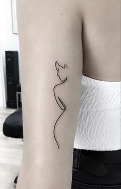 a woman's arm with a line drawing of a cat on the left side