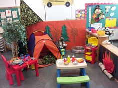 there are many children's toys in the room with tents and tables on the floor