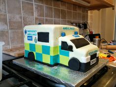 a cake shaped like an ambulance on top of a stove