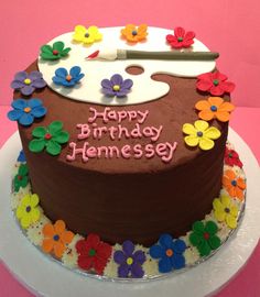 a birthday cake decorated with flowers and a guitar