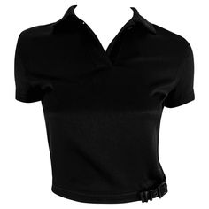 This chic black crop top from Gianni Versace’s Spring/Summer 1996 collection features a sharp collared neckline and a unique buckle detail at the waist. Approximate measurements: Size - Removed Shoulder to hem: 17 Bust: 32” - 34” Waist: 24” - 26” Material tag removed Top Noir, Versace Couture, Versace Brand, Oversized Tunic, Black Crop Top, Shoulder Shirts, Gianni Versace, Black Crop, Black Crop Tops