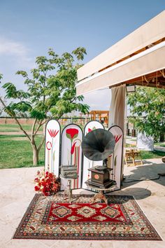 an outdoor area with furniture and rugs on the ground, including a large horn