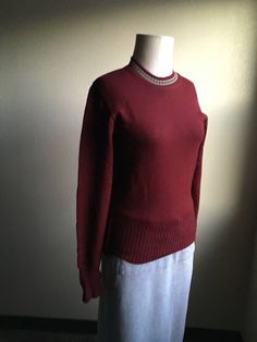 "1950s Octonek Knitting Co. wool pullover sweater maroon w/grey neck stripes wide rib cuffs/hem made in Seattle, WA, USA original owner's name tag good vintage condition, light wear has a slight moth ball odor elbow patches on inside of sleeves no size tag, fits like an xs/s measures, lying flat, unstretched, shoulder- 16\" chest- 17\" hem- 12\" sleeve- 25\"" Vintage Solid Sweater For Fall, Vintage Solid Color Sweater For Fall, Solid Vintage Sweater For Fall, Vintage Sweater With Ribbed Collar For Fall, Vintage Sweater For Fall, Vintage Polo Sweater With Ribbed Collar And Crew Neck, Vintage Winter Sweater With Ribbed Collar, Vintage Winter Sweater With Ribbed Cuffs, Classic Crew Neck Sweater With Striped Cuffs