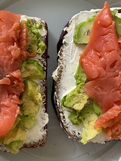 two pieces of bread with avocado and salmon on them