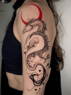 a woman's arm with a dragon tattoo on it and a red circle around the arm