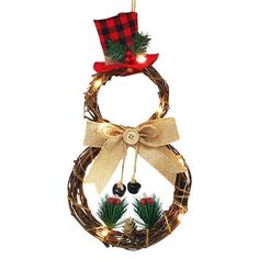 a christmas wreath with lights and decorations hanging from it's front loop, decorated with pine cones