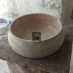 a stone bowl sitting on top of a wooden table