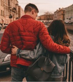 a man and woman are walking down the street