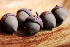 four pieces of chocolate sitting on top of a wooden table