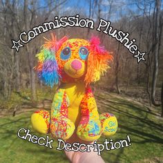 a person holding up a stuffed animal with the caption commission plushz check description