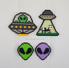 some pixel art is hanging on the front door and it looks like they are in outer space