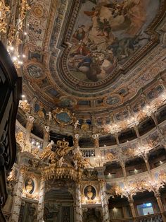 an ornately decorated room with chandeliers and paintings on the ceiling