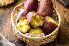 a basket filled with potatoes sitting on top of a wooden table