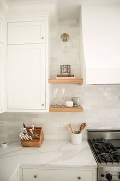 an image of a kitchen with white cabinets and marble counter tops on the appliance page