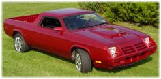 a red pick up truck parked in the grass