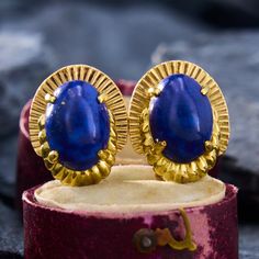 This vintage pair of drop earrings each feature an oval cabochon cut lapis that is accented by layered and fluted gold that enhances the oval shape.  They are crafted in 14k yellow gold and are finished with posts and omega backs. Lapis Earrings, Motif Vintage, Oval Cabochon, Oval Shape, Jewelry Earrings, Yellow Gold, Drop Earrings, Yellow, Gold