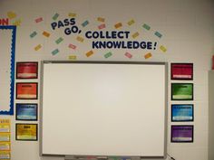 a white board mounted to the side of a wall next to a bulletin board that says pass go, collect knowledge