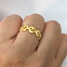 Handmade skull eternity ring made from sterling silver and plated in genuine yellow gold. Approximate dimensions Metal: high quality 925 sterling silver Plating: 24K yellow gold Skull width: 6mm Skull height: 6mm Thickness: 1.5mm Following sizes can ship within 1-2 business days. Size 5, 5.25, 5.5, 5.75, 6, 7, 7.25, 7.50, 7.75, 8, 8.25, 8.5, 8.75, 9 4-6 weeks production lead time for sizes that are not listed as in stock. We can make US ring size 4 to 14. Please contact us to start a cust... Gold Gothic Wedding Rings, Gothic Gold Rings For Anniversary, Gold Gothic Jewelry For Anniversary, Interesting Wedding Rings, Skull Wedding Ring, Gothic Engagement Ring, Skull Engagement Ring, Engagement Ring Gold, Handmade Skulls