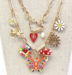 "Gold multi charm double layer necklace first layer is 16\" with 3\" extender chain. Lots of fun cute charms, butterfly daisy flower, dragonfly, butterfly, mushroom, hearts and more." Whimsical Multicolor Jewelry With Charms, Whimsical Multicolor Charms Jewelry, Whimsical Multicolor Jewelry With Dangling Charms, Cute Multicolor Jewelry With Removable Charms, Whimsical Dangle Charm Necklaces, Cute Nickel-free Metal Charm Necklaces, Cute Metal Charm Necklace Nickel Free, Cute Nickel-free Metal Charm Necklace, Whimsical Dangle Jewelry With Flower Charm