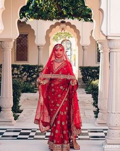 a woman in a red bridal outfit