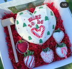 a valentine's day cake in a box with strawberries and candy