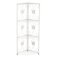 a white metal corner shelf with butterflies on the top and two shelves below it,