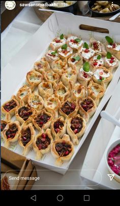 an appetizer tray filled with pastries and dips