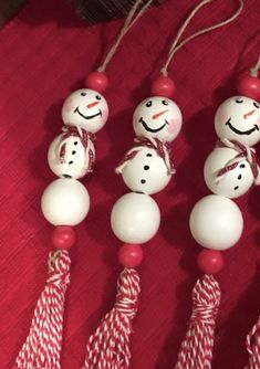 four snowmen with candy canes attached to them