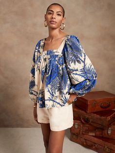 An ideal design for sunnier days, this light and flowing style is crafted from beautiful, breathable cotton using romantic details like dramatic volume in the sleeves and body, with shirring at the neckline and a pleated detail at the sleeves and hem Pucci Pattern, Square Neck Blouse, African Blouses, Blackbird, Fashion Studio, Balloon Sleeves, Floral Blouse, Printed Blouse, Santorini