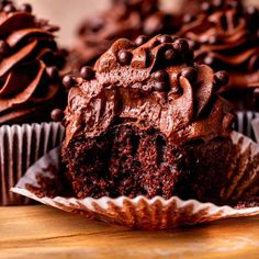 chocolate cupcakes with chocolate frosting and chocolate chips on the top are ready to be eaten