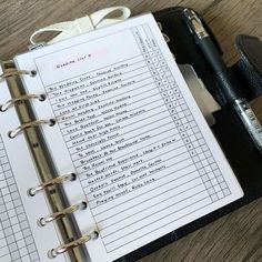 an open planner book sitting on top of a wooden table